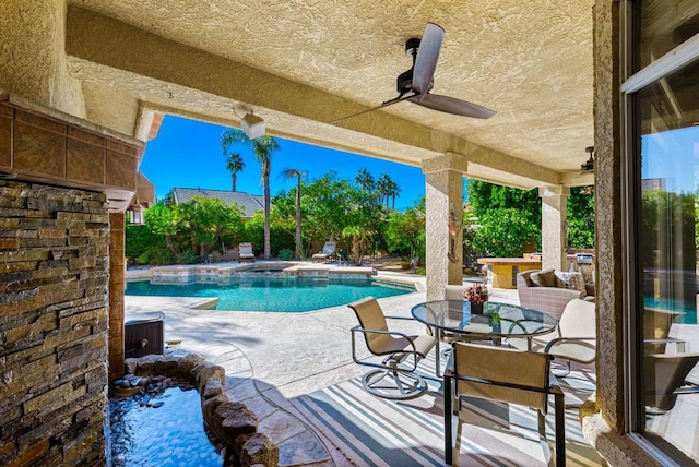 view of pool featuring an in ground hot tub, ceiling fan, and a patio