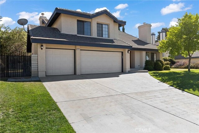 view of front property with a front yard and a garage