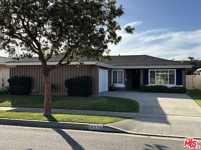 ranch-style home with a front lawn and a garage