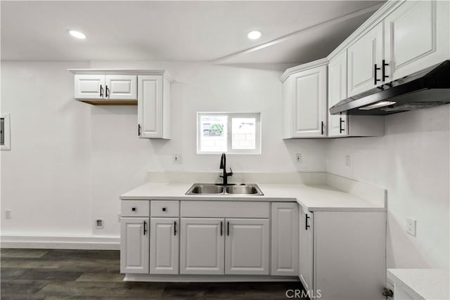 kitchen with dark wood-type flooring, sink, and white cabinets