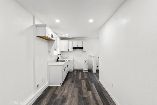 kitchen with sink, white cabinetry, and dark hardwood / wood-style floors