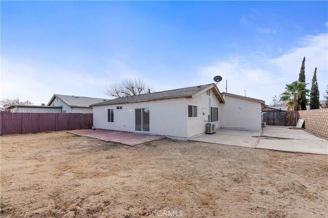 back of property with a patio area and central AC