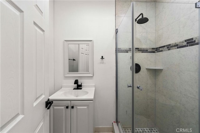 bathroom featuring vanity and a shower with door