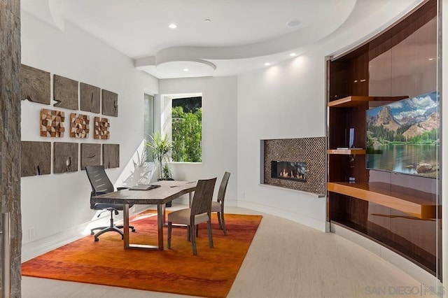 dining area with a fireplace and light hardwood / wood-style flooring