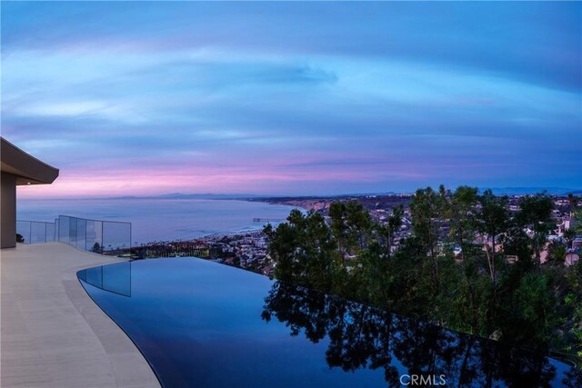 pool at dusk with a water view