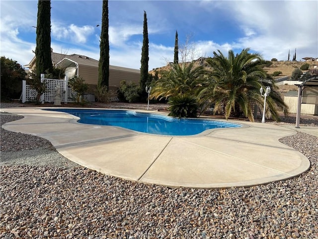 pool with fence and a patio