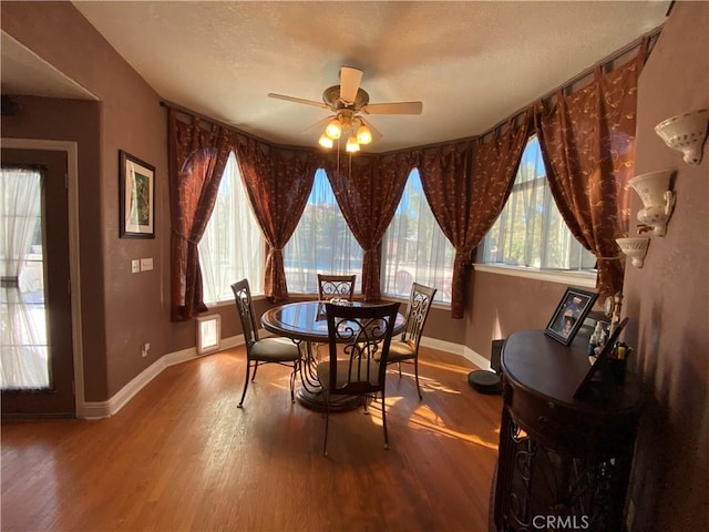 dining room featuring plenty of natural light, baseboards, and wood finished floors