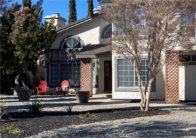 back of house featuring stucco siding