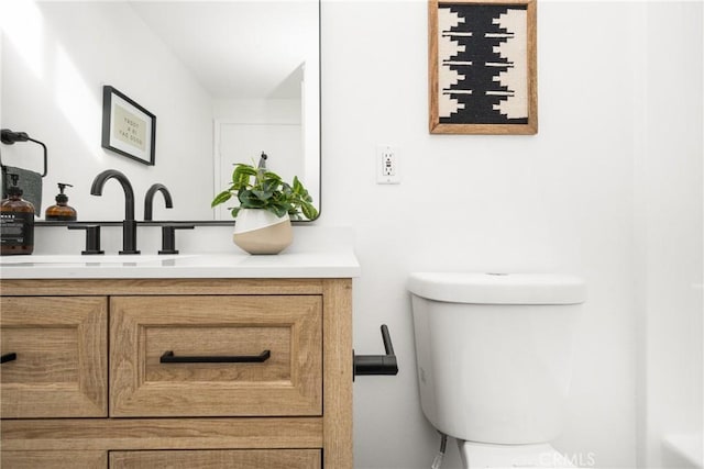 bathroom with toilet and vanity