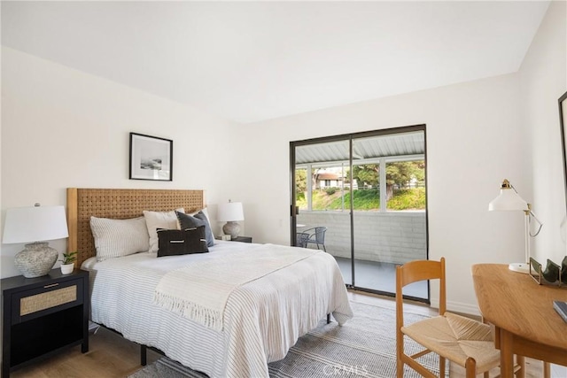 bedroom featuring light wood-style floors and access to exterior