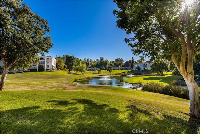 surrounding community featuring a yard and a water view