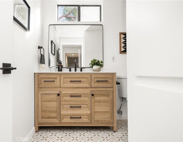 bathroom with toilet and vanity