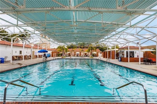 community pool with a patio and a lanai