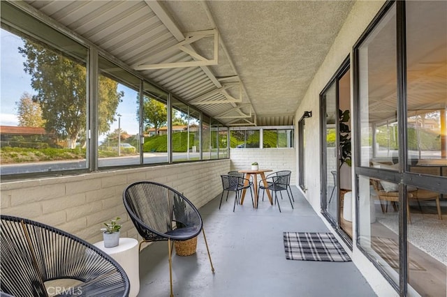 sunroom featuring outdoor dining area