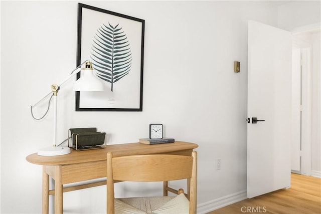 office featuring baseboards and wood finished floors