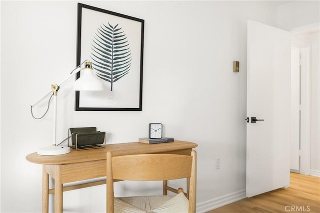 office featuring baseboards and wood finished floors