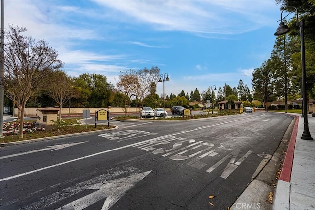 view of road with curbs, street lighting, and sidewalks