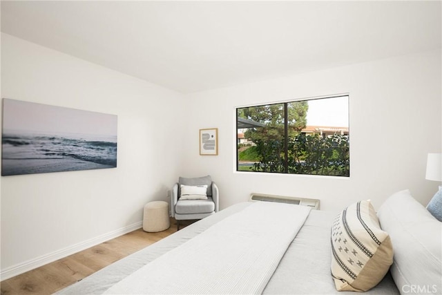 bedroom with baseboards and wood finished floors
