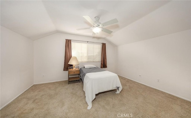 bedroom with vaulted ceiling, ceiling fan, and light carpet