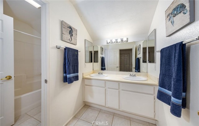 bathroom featuring vaulted ceiling, tile patterned flooring, and vanity