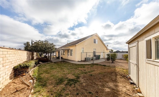 view of property exterior with central air condition unit, a yard, and a patio