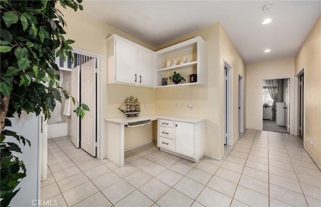 kitchen with white cabinets and light tile patterned flooring