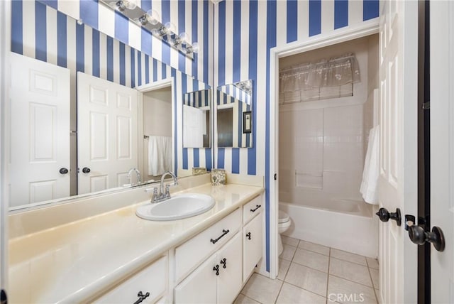 full bathroom featuring toilet, tile patterned flooring, tiled shower / bath combo, and vanity