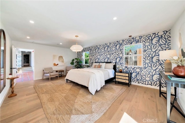 bedroom featuring light wood-type flooring, wallpapered walls, baseboards, and recessed lighting