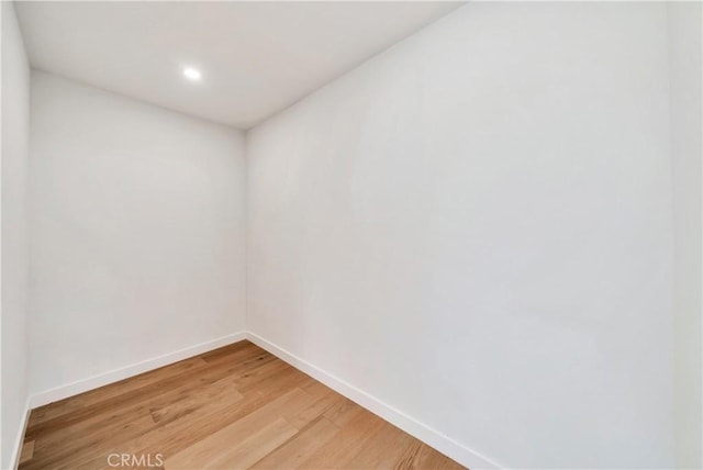 unfurnished room featuring light wood-style flooring and baseboards