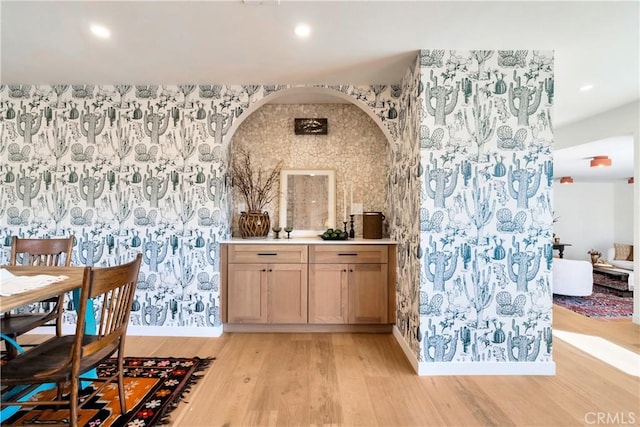 bar with recessed lighting, light wood finished floors, and wallpapered walls