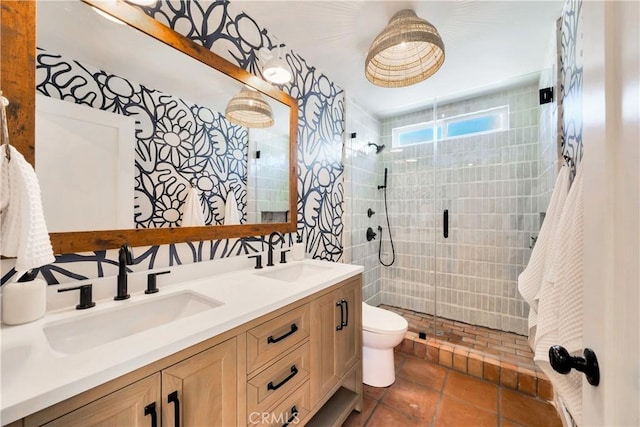 full bathroom with a sink, a shower stall, and double vanity