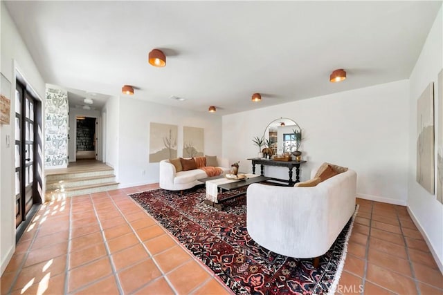 tiled living room featuring baseboards