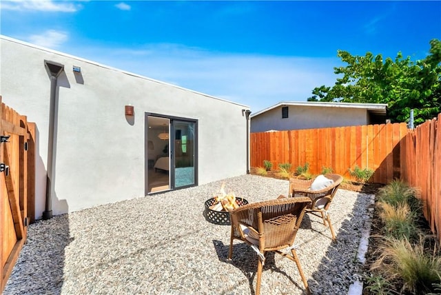 view of patio / terrace with an outdoor fire pit and fence