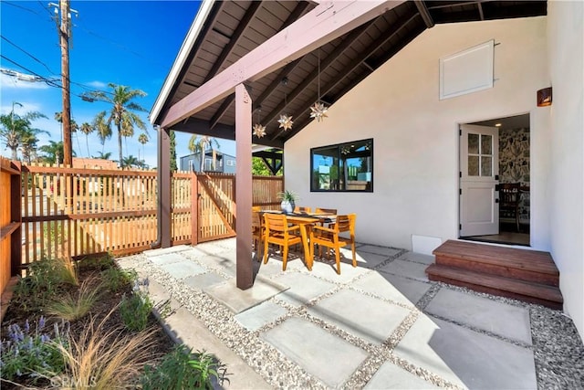 view of patio / terrace featuring outdoor dining area and fence