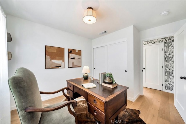 office area featuring light wood-style floors and baseboards