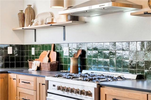 kitchen with tasteful backsplash, light brown cabinetry, wall chimney range hood, and range