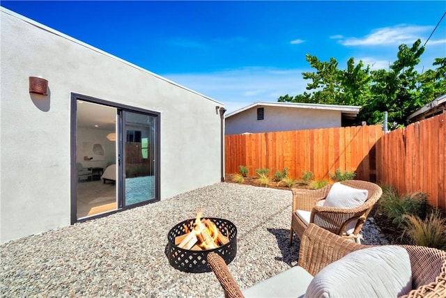 view of patio / terrace featuring an outdoor fire pit and fence