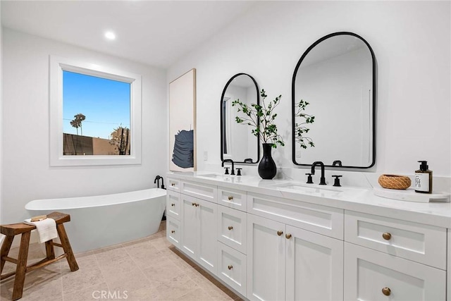 bathroom featuring a tub to relax in and vanity