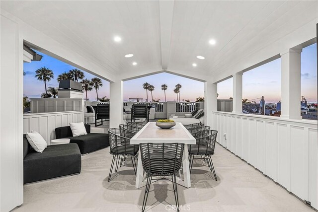 patio terrace at dusk featuring an outdoor hangout area