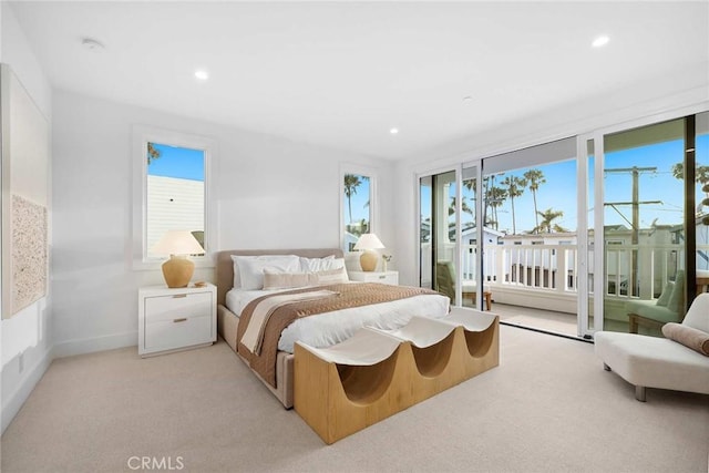 carpeted bedroom featuring access to exterior and multiple windows