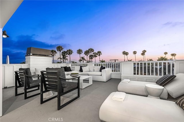 patio terrace at dusk featuring outdoor lounge area