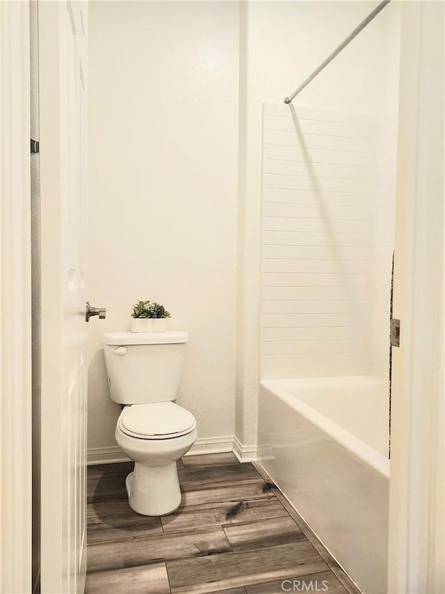 bathroom with shower / bathing tub combination and toilet