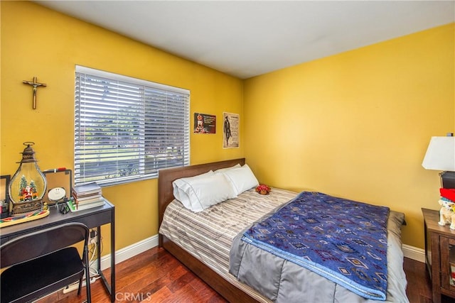 bedroom with dark hardwood / wood-style flooring