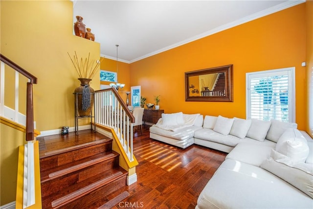 living room with an inviting chandelier, ornamental molding, and hardwood / wood-style flooring