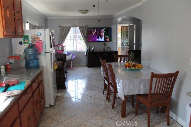 tiled dining room with ornamental molding