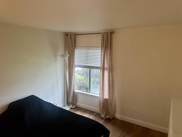 unfurnished bedroom with hardwood / wood-style floors