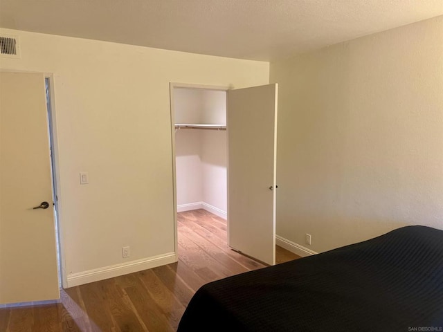 unfurnished bedroom with a closet and hardwood / wood-style floors