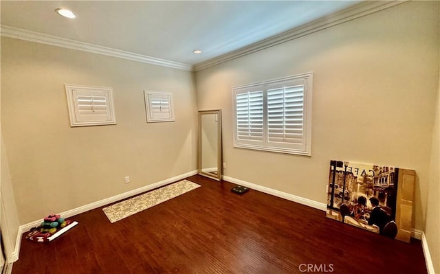 spare room with crown molding and dark hardwood / wood-style floors