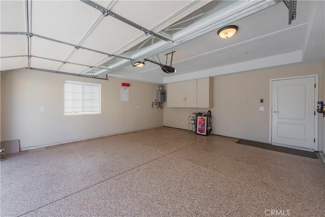 garage with electric panel and a garage door opener