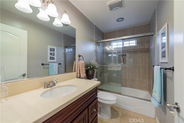 full bathroom with toilet, tile patterned floors, combined bath / shower with glass door, and vanity